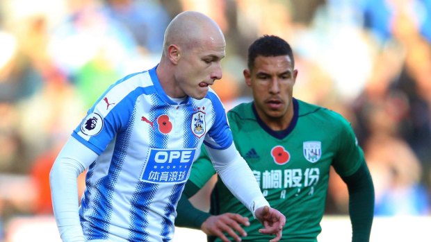 Hard-fought win: Huddersfield Town's Aaron Mooy, left, and West Bromwich Albion's Salomon Rondon battle for the ball.