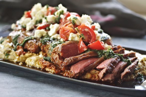 Spiced lamb slices resting on a bed of creamy white bean puree, scattered with spiced herb gremolata.