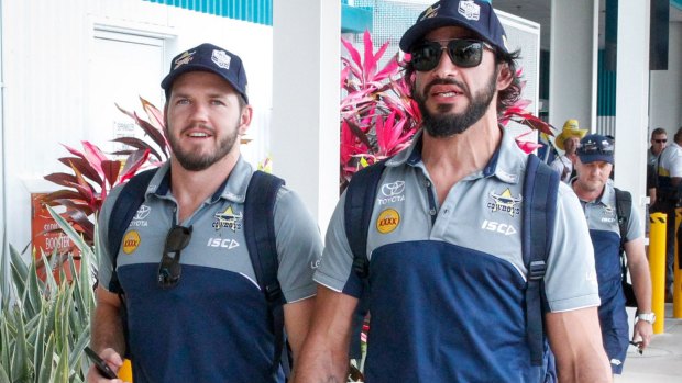 Lachlan Coote and Johnathan Thurston of the Cowboys are greeted by fans at the Townsville Airport.