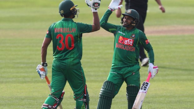 Bangladesh's Mahmudullah, left, celebrates with teammate Mushfiqur Rahim after hitting a four to win the Tri-Nations series match.