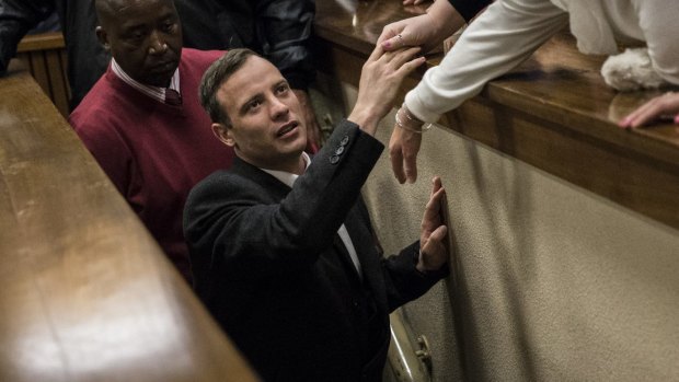 Oscar Pistorius holds the hand of a relative after his sentencing on July 6.