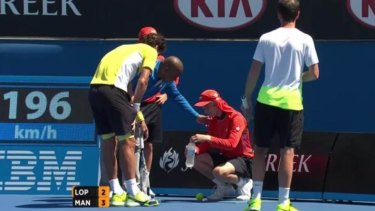 Painful blow: a ball boy receives treatment on Showcourt three.