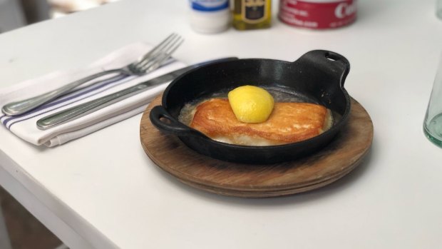 Cheese saganaki at Mandolin is served bubbling in a cast iron skillet and doused with fresh lemon at the last minute.
