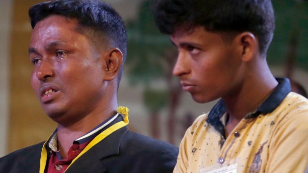 A Rohingya Muslim refugee, left, breaks down after meeting Pope Francis at an interfaith peace meeting in Dhaka, Bangladesh.