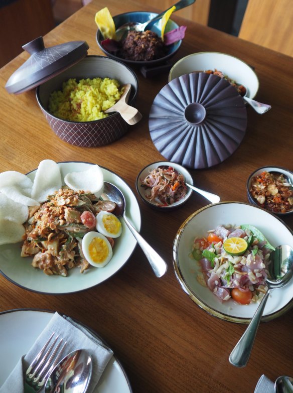 Clockwise from top left: Gado gado, turmeric coconut rice, braised beef, and smoked trevally braised in a mild curry at Kaum.