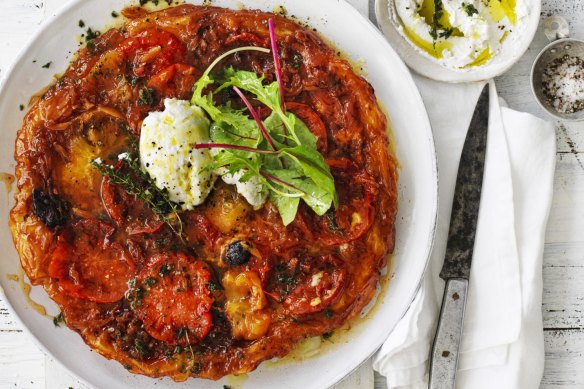 Tomato tarte tatin served with goat's curd and salad leaves.