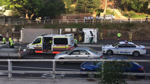 A truck lies on its side on Warringah Road in Dee Why following an accident.