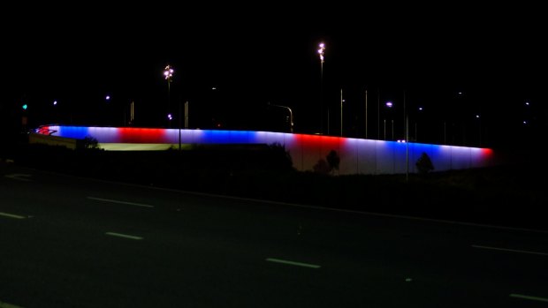 The Kings Avenue bridge in Canberra lit up in the colours of the French flag.