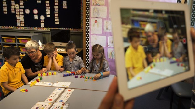 Teacher  Jann Barry is filmed helping solve maths problems with her students at Leichhardt Public School.