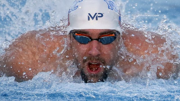 Winning return: Michael Phelps  wins the 100 metre butterfly final.