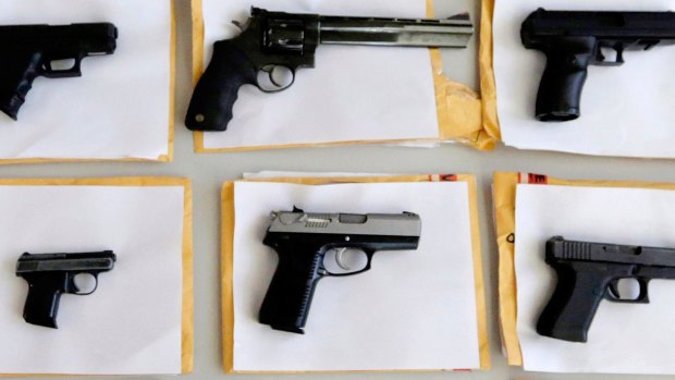 Chicago police display some of the thousands of illegal firearms they confiscated during the year in their battle against gun violence in Chicago. 