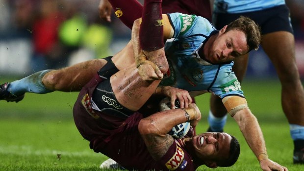Heartache: James Maloney tackles Darius Boyd in the Blues' loss to the Maroons on Monday night.