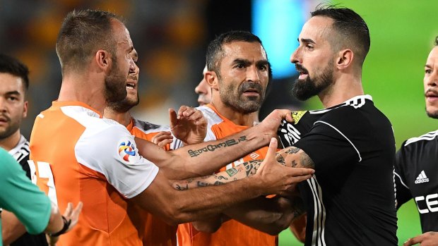 Tempers flare: The Roar's Ivan Franjic gets involved in an altercation with Ceres player Manuel Herrera at the Queensland Sports and Athletics Centre.