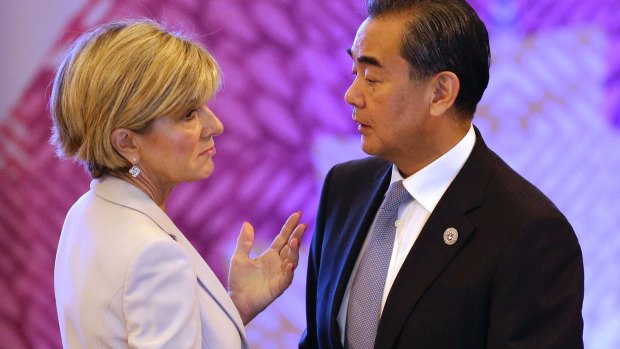 Chinese Foreign Minister Wang Yi, right, talks with his Australian counterpart Julie Bishop at the ASEAN forum in the Philippines.