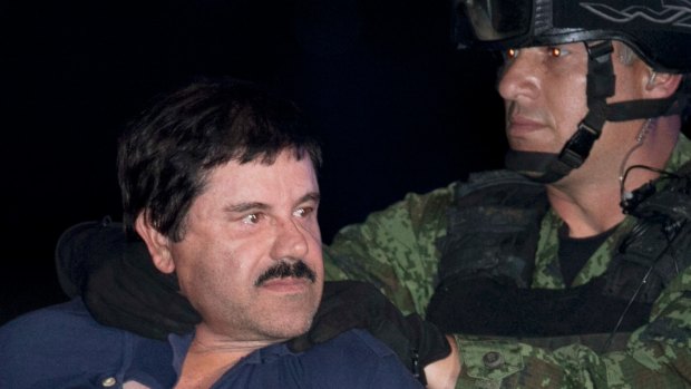 Joaquin "El Chapo" Guzman is made to face the media as he is escorted to a helicopter after his arrest.