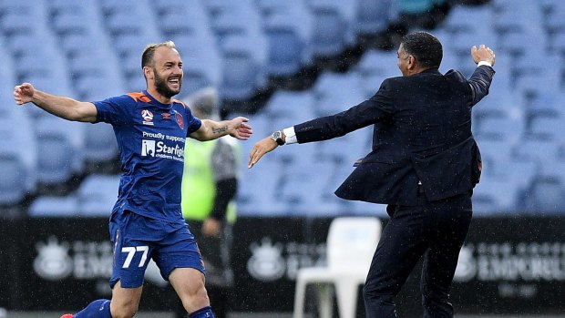 Match-winner: Ivan Franjic celebrates with Roar coach John Aloisi after sealing the game.