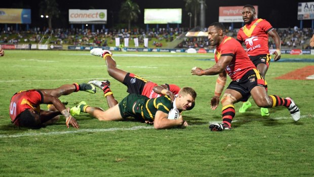 Unstoppable: Tom Trbojevic dives over for the Kagaroos in Suva.