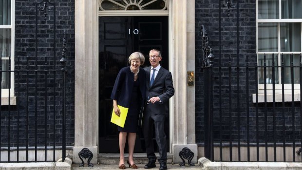 Theresa May, UK prime minister, and her husband Philip May, pose for photographers outside 10 Downing Street in London.