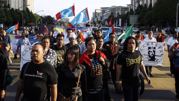 Supporters of Malaysian opposition leader Anwar Ibrahim march towards the Palace of Justice in Putrajaya on Tuesday.