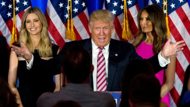 Ivanka Trump stands behind her father and alongside her step-mother Melania.