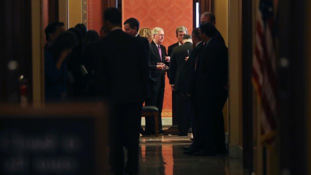 Senate Majority Leader Mitch McConnell, centre, and senator Roy Blunt at the end of a close-door meeting with on day three of the government shutdown. 
