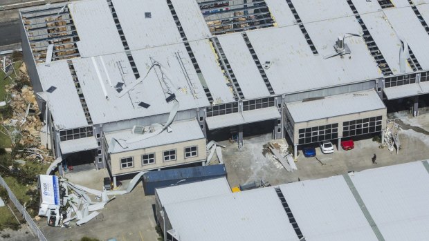 A truck lies on its side next to damaged buildings at the Kurnell plant.