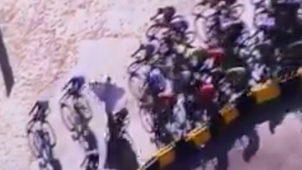 The Tour peloton takes evasive action to dodge around the protestor.