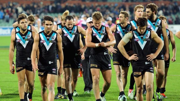 Port Adelaide players leave the field after losing to Geelong.