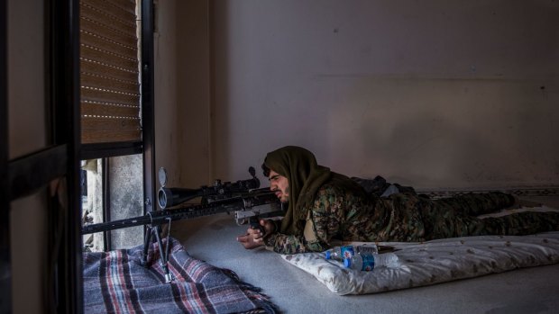 A Syrian Democratic Forces sniper on the watch for Islamic State fighters in Raqqa.