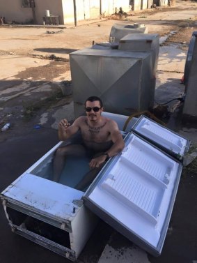 Ashley Dyball poses in an abandoned fridge, "no bathtub no problem".