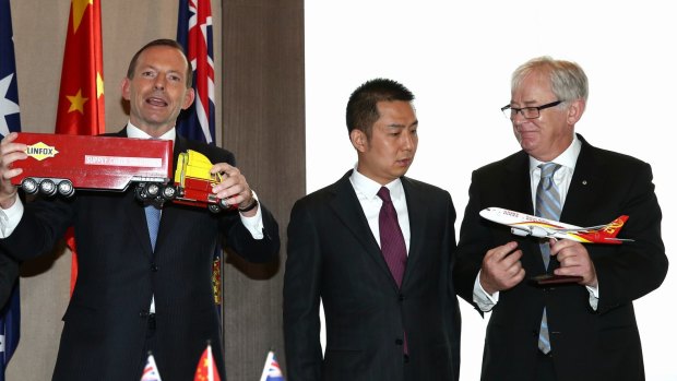 Prime Minister Tony Abbott, Huang Gan, executive director of HNA Group, and Minister for Trade and Investment, Andrew Robb during a visit to Shanghai in 2014. 