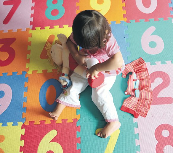 The man got angry after he tripped over the girl, who was playing on the floor.