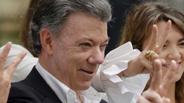 Colombia's President Juan Manuel Santos makes the victory sign after voting in a referendum in October.