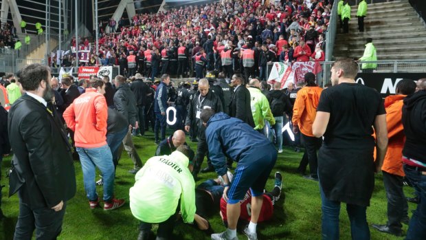 Medics tend to wounded Lille' supporters following the stadium collapse.