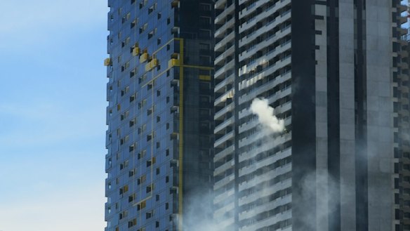 Smoke billowing from apartment fire in a building in Spencer Street.