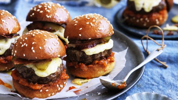 Beef sliders with bacon, cheese and pickles.