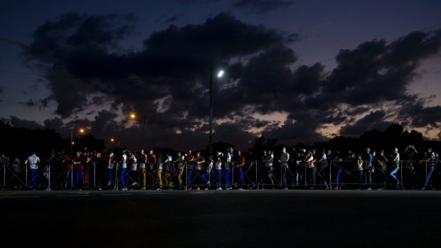 People wait in line at night to pay their final respects to the late Fidel Castro in the Revolution Plaza in Havana, Cuba.
