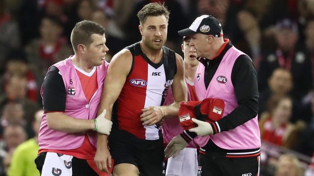 Future in doubt: Sam Fisher is escorted from the field after being hit by Toby Nankervis.