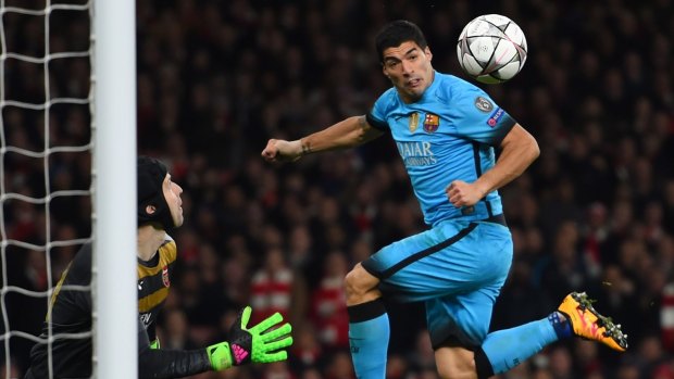 Close one: Luis Suarez of Barcelona directs a header at the goal of Petr Cech of Arsenal.