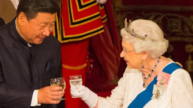Chinese President Xi Jinping and Queen Elizabeth II clink glasses at a state banquet at Buckingham Palace.