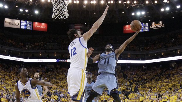 Rock solid: Andrew Bogut gets up in defense against Memphis guard Mike Conley.