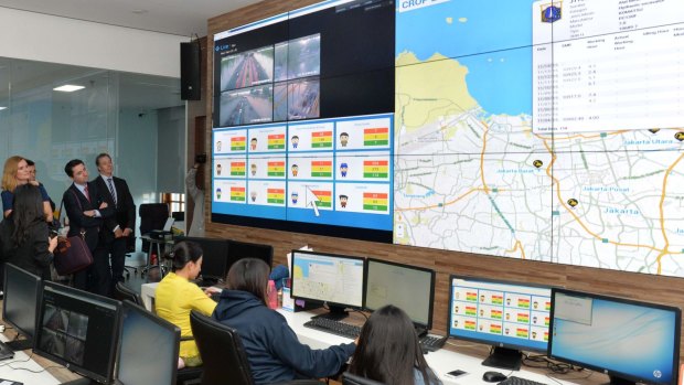 Australian journalists are shown the workings of the Jakarta Smart City team, who monitor problem spots across the city for flooding, rubbish build-up and traffic congestion, at Jakarta city hall.


