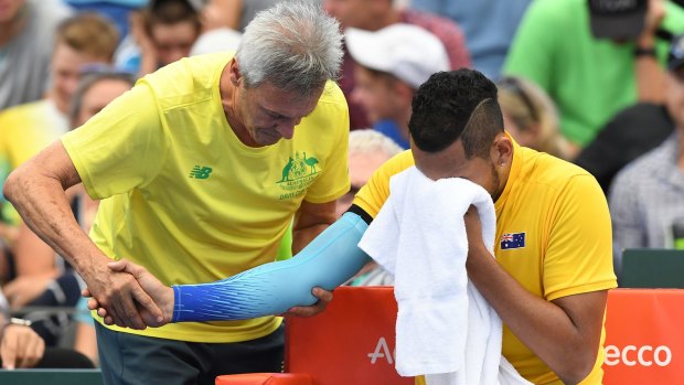 Hampered: Nick Kyrgios receives medical assistance during his straight sets loss to Alexander Zverev.
