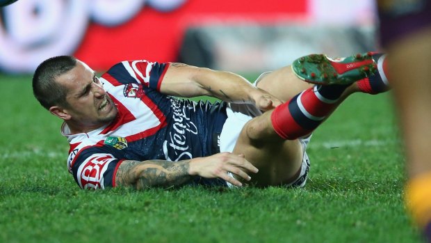 Early return?: Mitchell Pearce goes down with a hamstring injury against Brisbane.