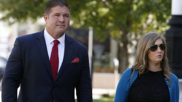 Jesse Benton, left, arrives for his sentencing hearing with his wife in September in Iowa. 