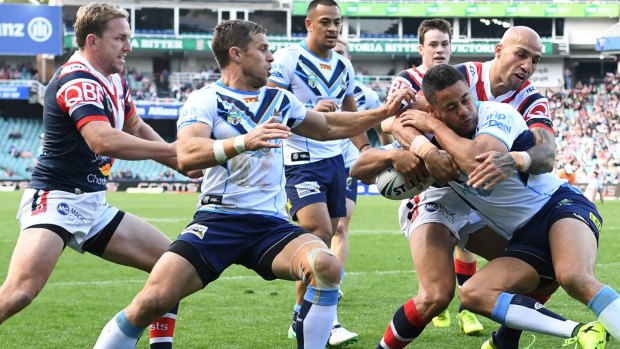 Out of the end zone: Roosters winger Blake Ferguson wraps up Titans star Jarryd Hayne.