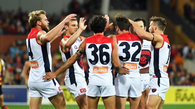 The Demons players celebrate a goal at Adelaide Oval.