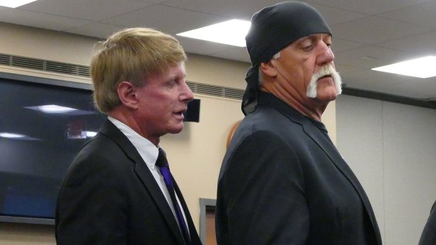 Attorney David Houston talks with his client Terry Bollea, known as professional wrestler Hulk Hogan, in court on Tuesday.