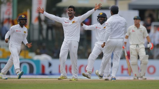 Opener gone: Sri Lanka's Dhananjaya de Silva celebrates the dismissal of David Warner early in Australia's first innings reply.