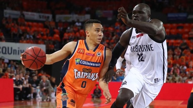 Travis Trice of the Taipans drives to the basket.